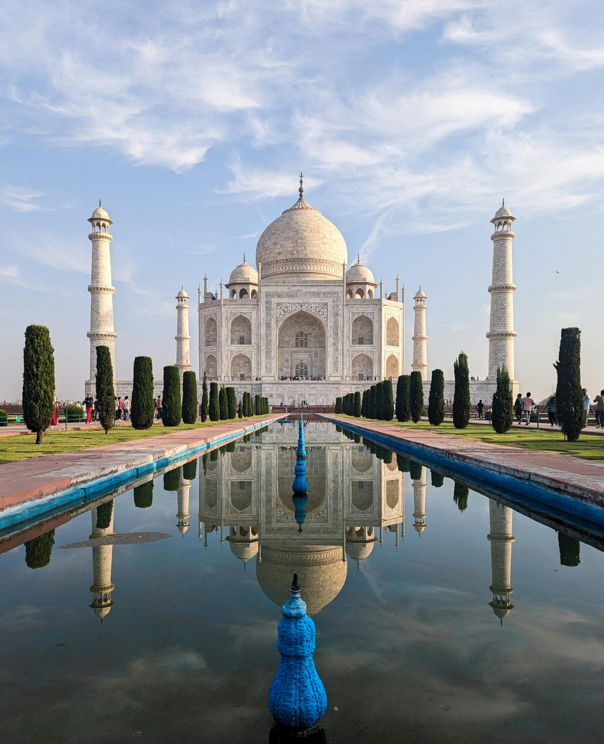 Iconic Taj Mahal with clear reflection in Agra, India. Captivating view on a sunny day.